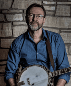 Tom Keeney with blue shirt and banjo